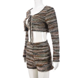 Detail of striped knit two-piece set featuring lace-up cropped cardigan and high waist shorts