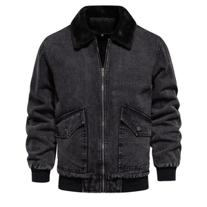 Detail of grey washed denim jacket featuring black faux fur collar and ribbed cuffs