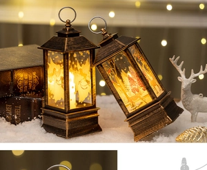 Detail of vintage bronze LED lanterns with angel and deer motifs in a snowy winter scene