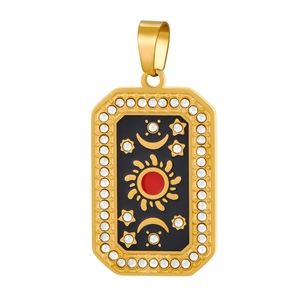 Detailed view of gold rectangle pendant with black enamel and celestial star moon motifs