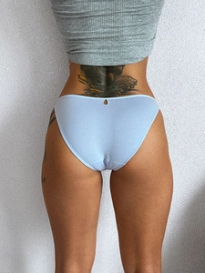 Rear view of light blue cotton bikini panties with thin straps on a model