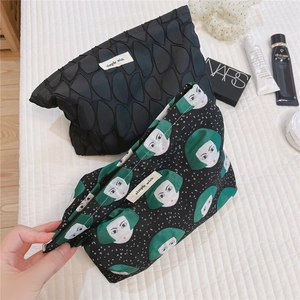 Detail of canvas makeup bags with leaf quilting and retro portrait print with zippers