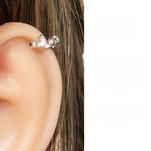 Detail of bunny ear cuff earring with pink enamel on a silver finish, clip-on style