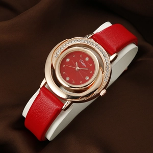 Close-up of luxury red leather women's quartz watch with crystal-encrusted gold case