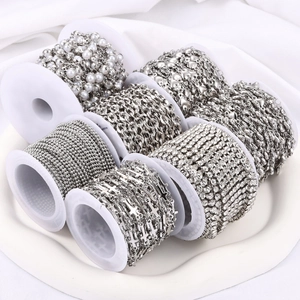 Variety of 7 silver stainless steel DIY jewelry chains in a white tray with soft lighting