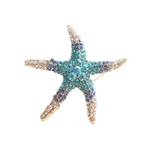 Sparkling zinc alloy starfish brooch with blue rhinestones and gold-plated finish