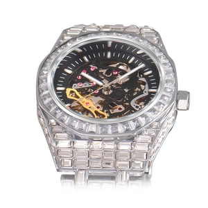 Macro shot of silver hip hop mechanical watch dial with clear view of gears and crystals