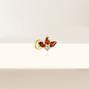 Detail of S925 silver earring with gold finish and orange marquise gemstones