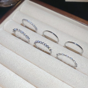 Detail view of a six-piece set of silver minimalist rings with cubic zirconia in a jewelry box
