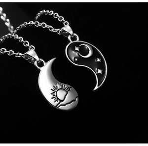 Macro view of Tai Chi sun and moon puzzle pendants for couples and friends
