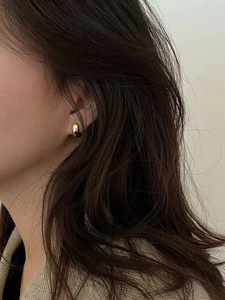 Minimalist gold hoop earrings for women shown on model for a trendy designer style