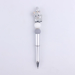 Detail of creative ballpoint pen with a gray cartoon goat and sparkling rhinestone beads