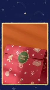Close-up of red Christmas gift bag with gingerbread man patterns and Xmas Mail sticker