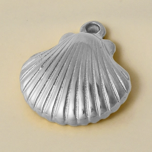 Close-up of polished 304 stainless steel shell charm with detailed textured surface