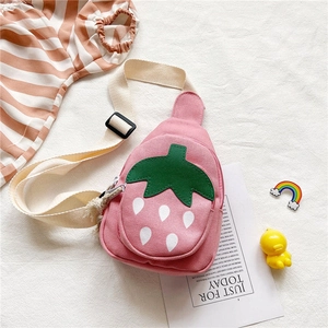Close-up of pink canvas strawberry bag with adjustable strap on a lifestyle backdrop