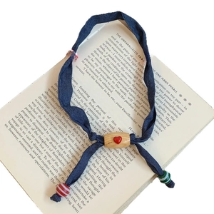 Knitted cherry pendant necklace with red heart wood beads on a dark blue fabric band