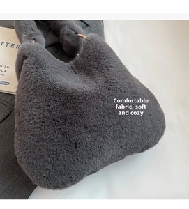 Detail shot of the dark grey plush tote bag showing soft faux fur and metallic ring connectors