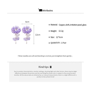 Detailed view of handmade purple fabric flower earrings with crystal tassels and size info