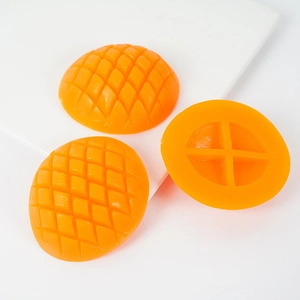 Artificial mango chunk prop for cake decoration with realistic orange flesh texture