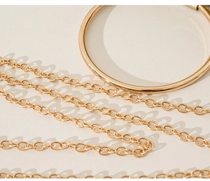 Detailed view of the gold chain strap and ring metal hardware for evening handbag