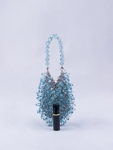 Detail of light blue crystal beaded handbag with teardrop beads and a lipstick for scale