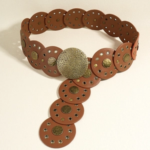 Detail of vintage Baroque brown leather belt with brass rings and large round buckle