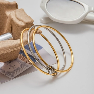 Classic 18K gold and silver plated stainless steel interlocking bangle set with zircon charm