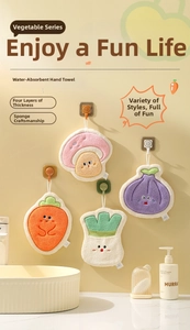 Detail of vegetable-shaped coral velvet towels with four-layer thick sponge hanging on the wall