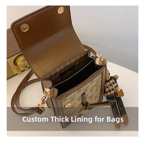 Close-up of vintage brown canvas crossbody bag showing interior lining and bear charm