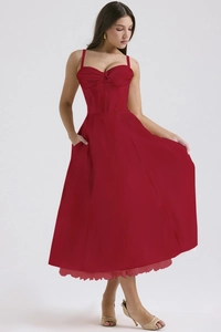 Detail of red corset floral dress featuring side pockets and delicate lace hemline
