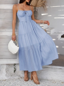 Detail of blue high-waist maxi dress with pleated tiered skirt for vacation parties