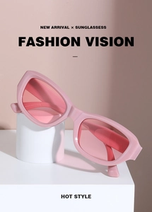 Detailed view of pink cat-eye sunglasses leaning on a white geometric prop in high fashion style
