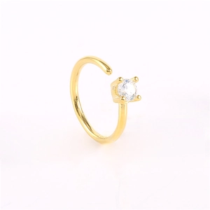 Macro shot of gold-plated seamless nose ring featuring a round white crystal setting