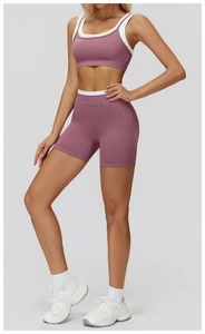 Detail of high-waist ribbed yoga shorts and sports bra in mauve with white trim