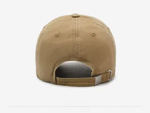 Detail of adjustable metal buckle and washed cotton texture on the khaki baseball cap