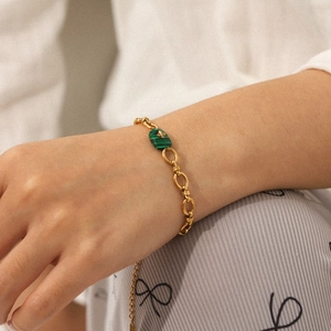 French vintage gold stainless steel bracelet with green malachite pendant on female wrist