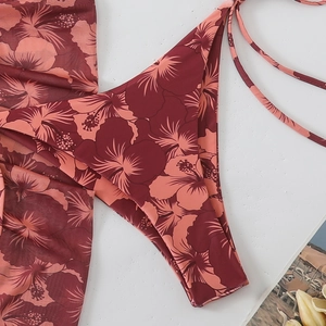 Detailed close-up of dark red bikini bottom with vibrant hibiscus floral print pattern