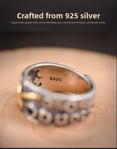 Macro shot of S925 hallmark on vintage silver ring with gold cross and blue gem