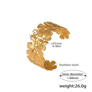 Detailed view of 18K gold plated stainless steel cuff bracelet with floral relief design
