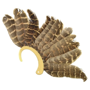 Detail view of vintage bronze ear cuff featuring natural layered brown striped feathers