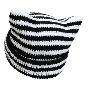 Detailed close-up showing the handmade knit texture of the black and white striped cat ear hat