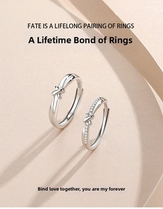 Macro shot of S925 sterling silver couple rings showing the Hallmark and knot design