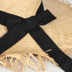 French raffia sun hat with black ribbon bow and fringed edge for summer beach vacation