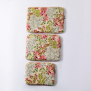 Three sizes of floral embroidered laptop sleeves with pink daisy pattern and zippers