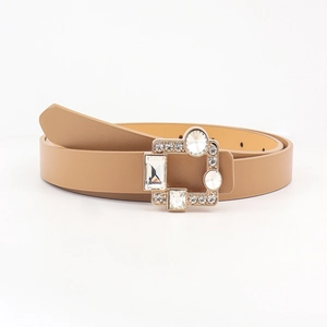 Detail of light brown thin PU belt featuring a gold buckle with large crystal rhinestones