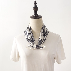 Elegant silk neck scarf with black and white print tied on model's neck for professional look