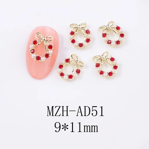 Detail of Christmas nail charm MZH-AD51 with gold bow, red rhinestones and pearls