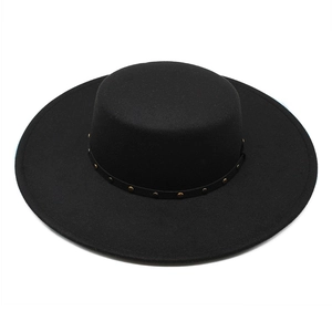 Detail of flat top black wool felt hat featuring a thin band with gold metal rivets
