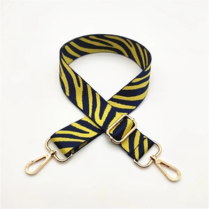 Adjustable zebra print strap in yellow and navy with gold hardware for handbags