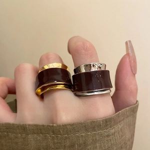 Detail view of retro double-layer open rings with vintage burgundy enamel and metallic finish
